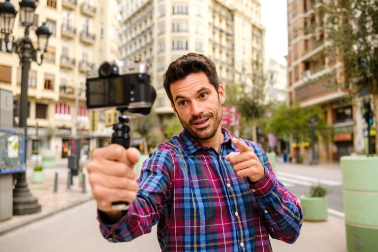 Person outdoors recording a video of himself on camera GNlAGIq