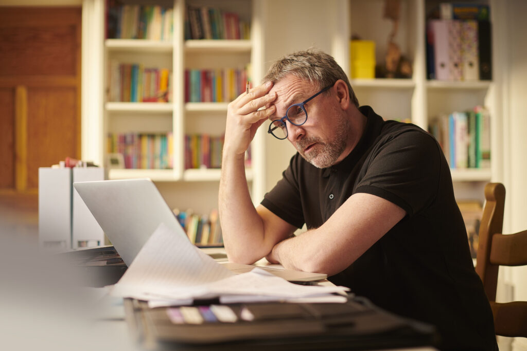 worried investor looking at computer