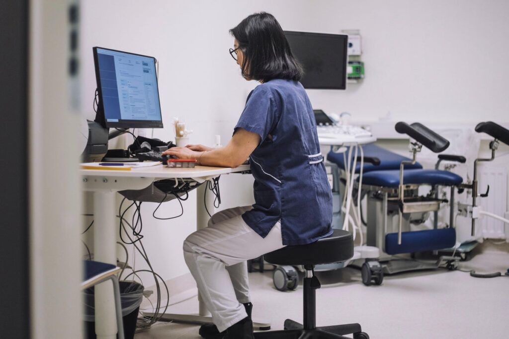 doctor using computer in exam room