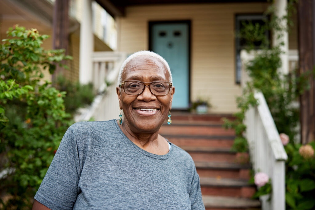 getty smiling happy by porch house