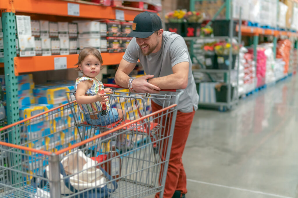 shopper pushes cart in a warehouse store