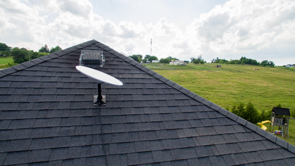 spacex starlink satellite dish on a rooftop in the countryside