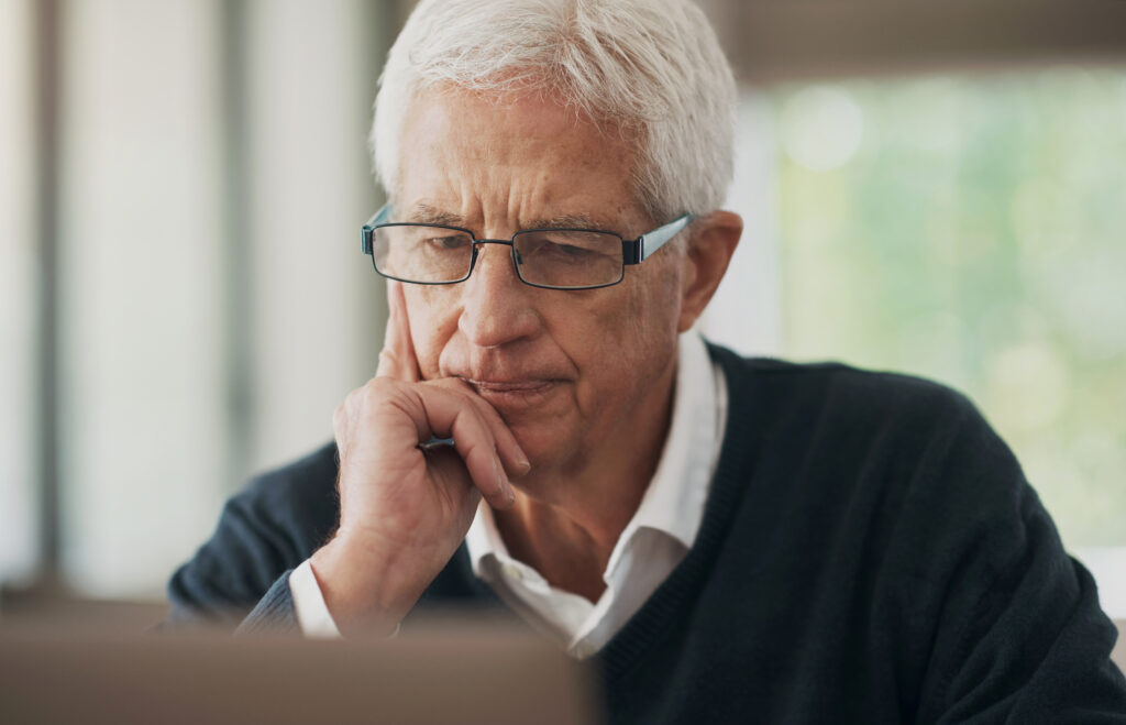 worried investor looking at a computer