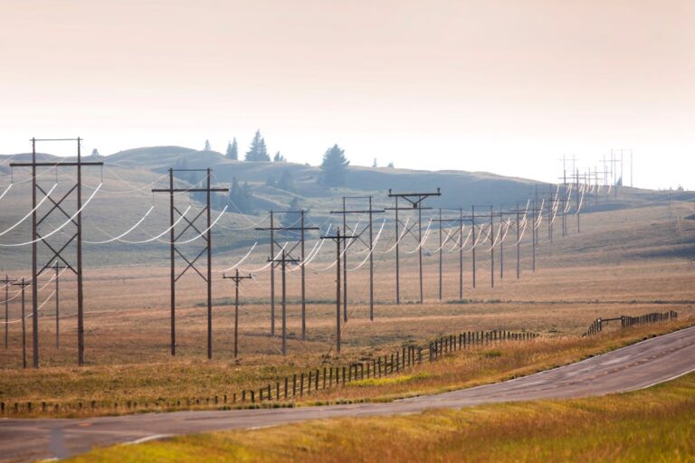 Electric lines at sunset in rural landscape