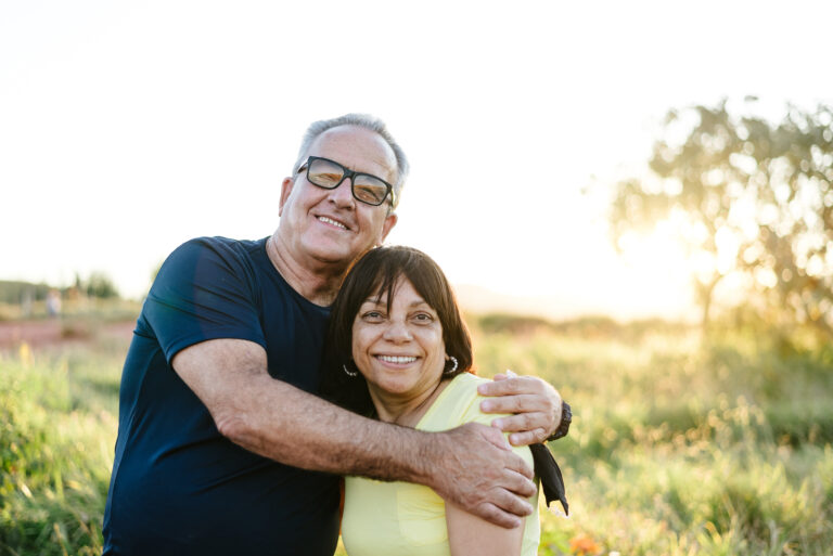 senior couple retire outside active retirement happy hug