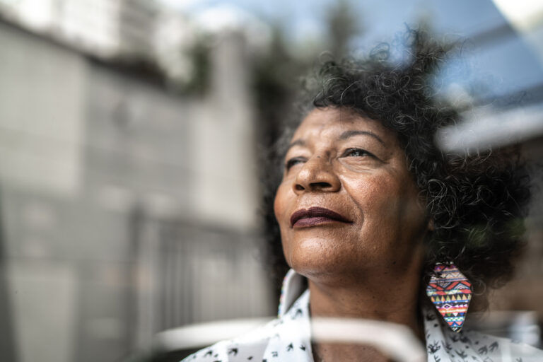 smiling person looking out window