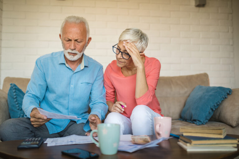 stressed couple looking at documents