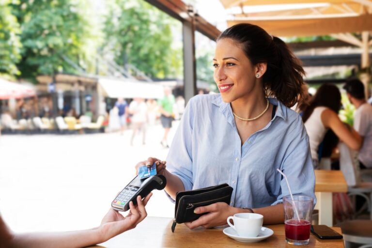 woman paying waitress with credit card