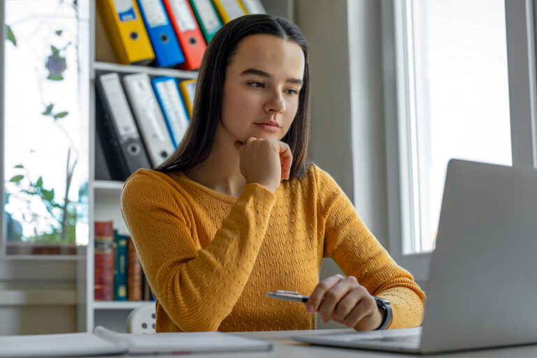 young woman looking at laptop